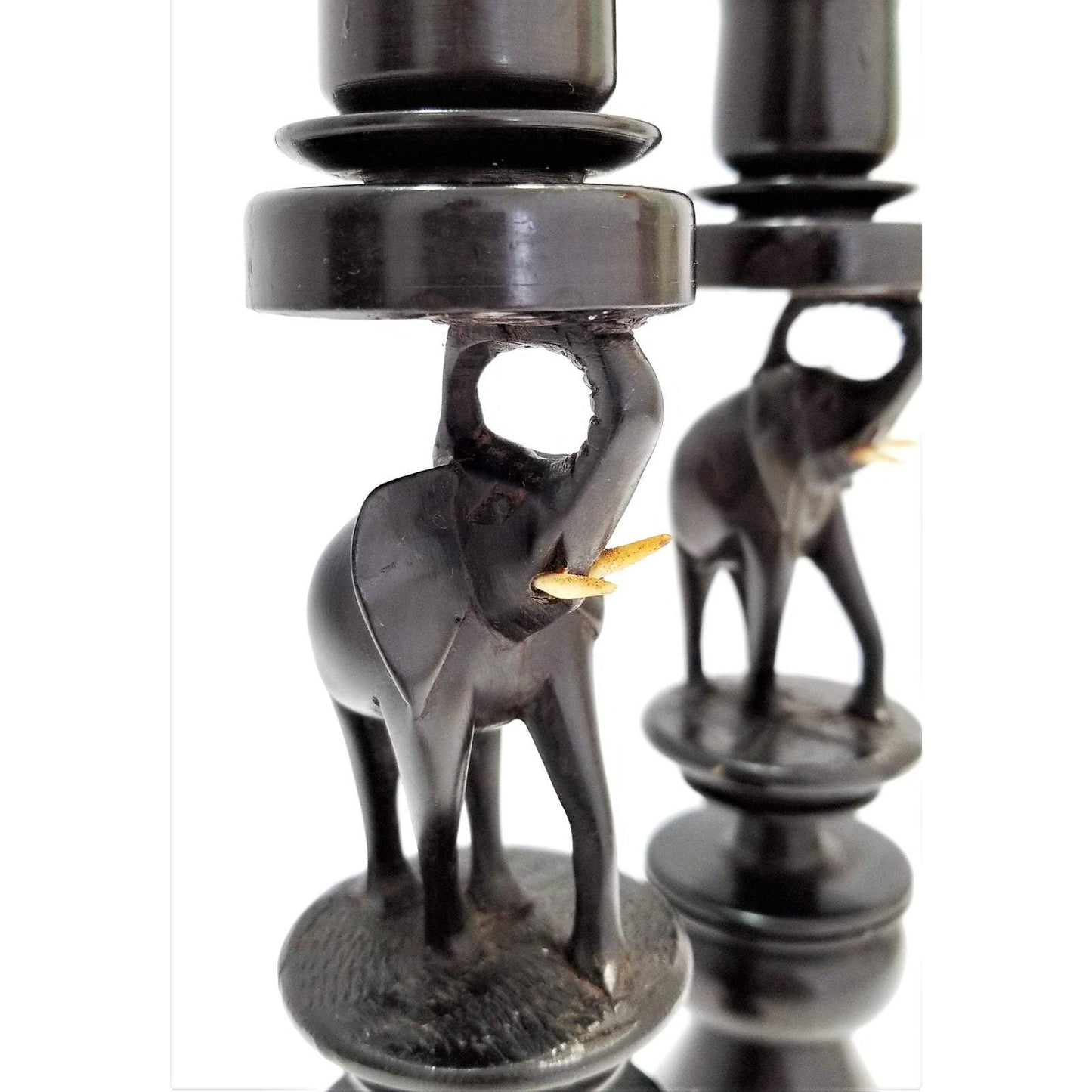 A pair of Elephant Curved Ebony Candle Holders